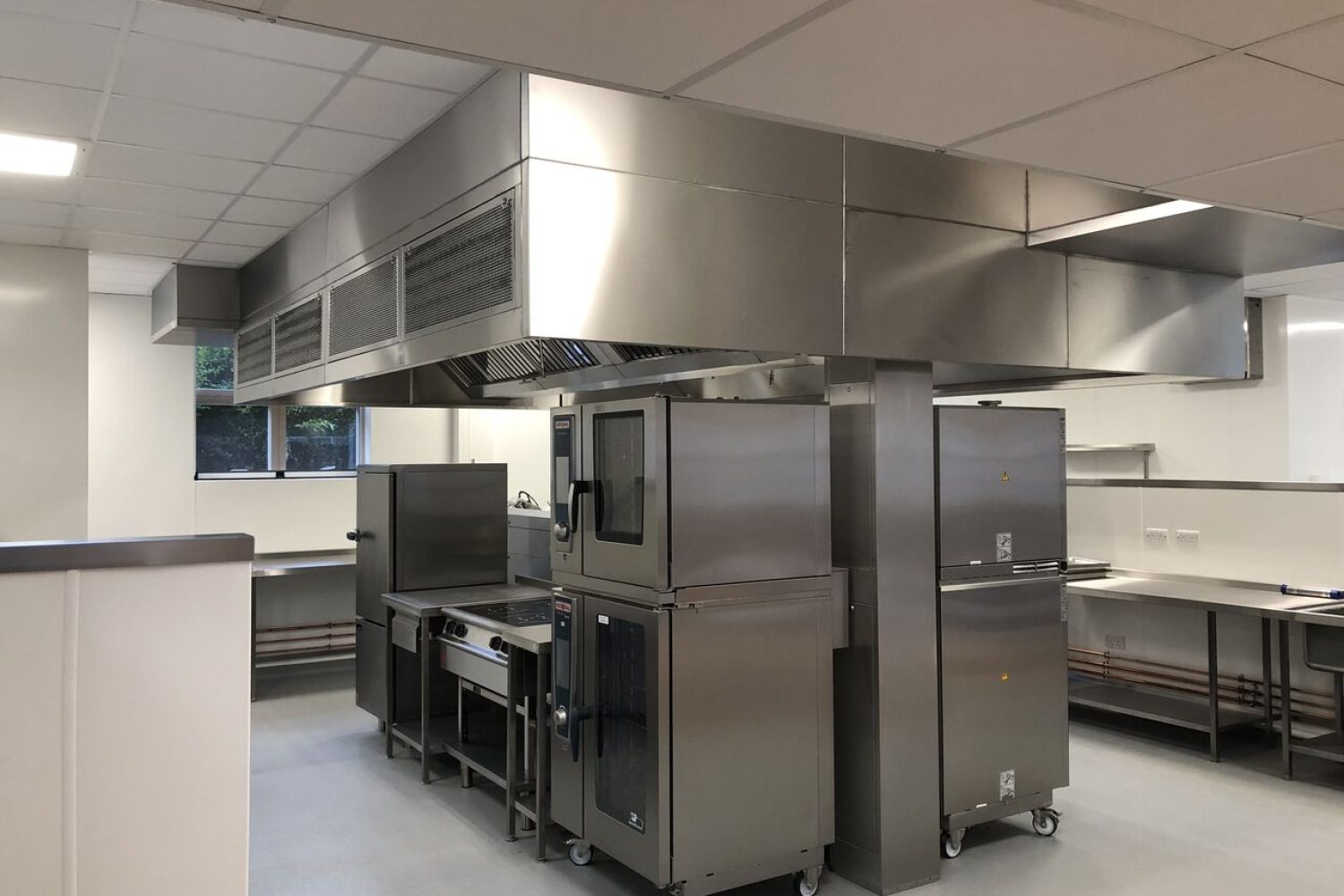 Professional commercial kitchen cookline featuring high-performance cooking equipment, stainless steel surfaces, and an efficient layout designed for seamless food preparation.
